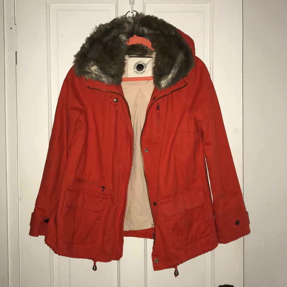 Orange jacket with fur hood.